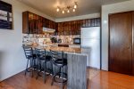 The kitchen has 3 barstools at the kitchen counter. The kitchen has new granite counters, and is fully equipped with all of the flatware, cookware, and utensils you need to prepare meals. 